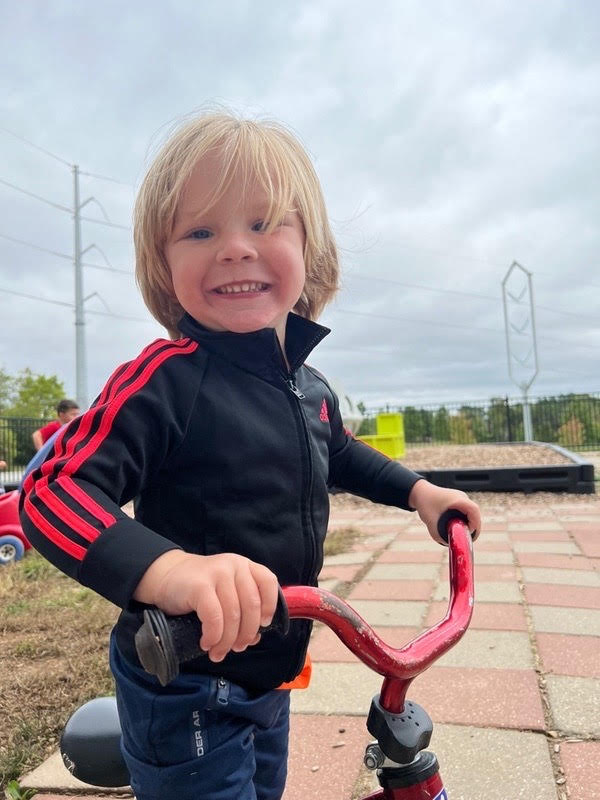 Kid playing a tri-cycle