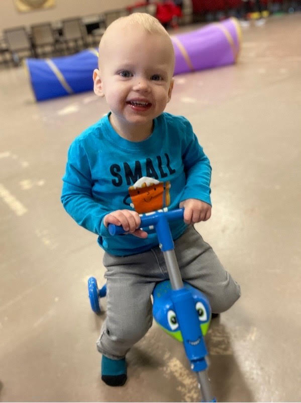 Boy riding a tri-cycle