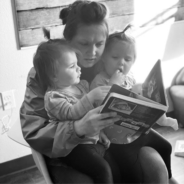 Teacher reading to two toddlers